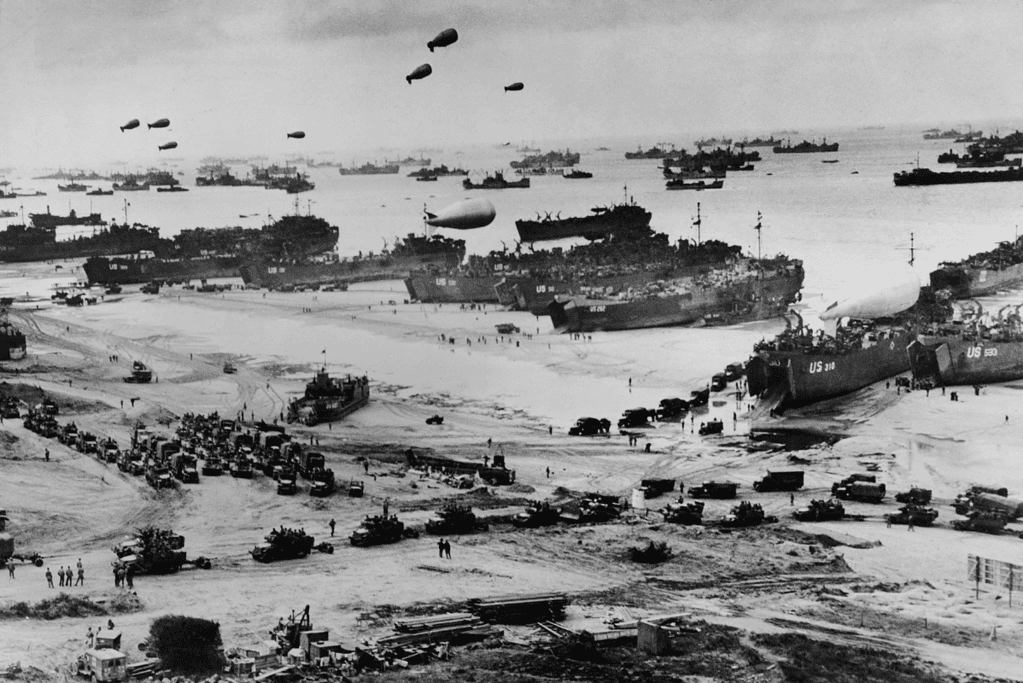 Image of military supplies being offloaded at Normandy beach during World War Two