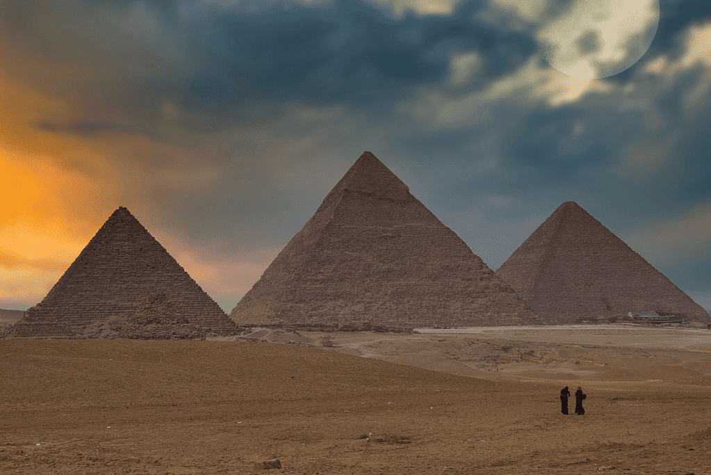 Image of the Great Pyramids of Giza in Egypt at dusk.