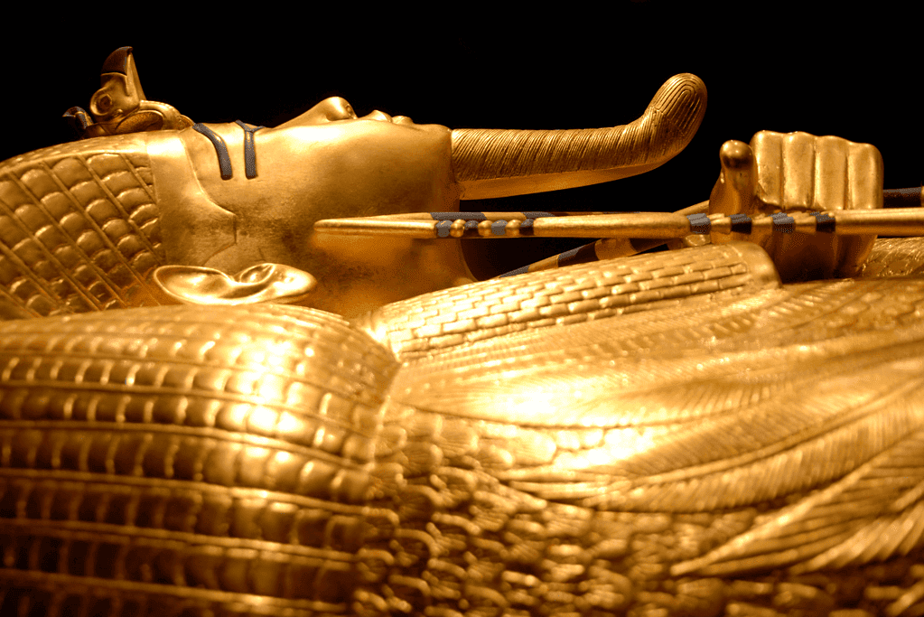 Image of a gold sarcophagus of King Tutankhamun, a resplendent artifact showcasing the opulence and artistry of the pharaohs of ancient Egypt.