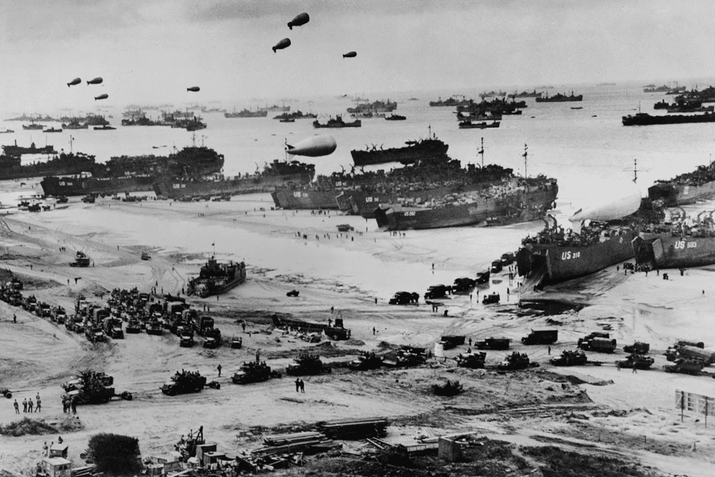 Image of troops and supplies being offloaded after the Battle of Normandy in World War II