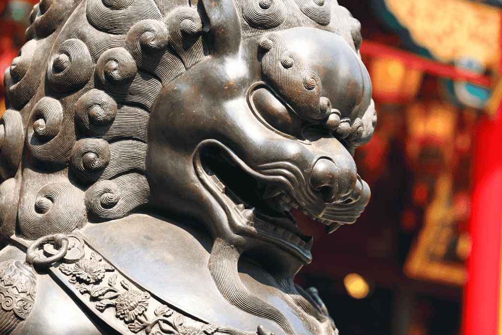 Image of a bronze lion statue adorning a temple in China, embodying the enduring spirit of guardian sculptures for an article about an influential china dynasty list