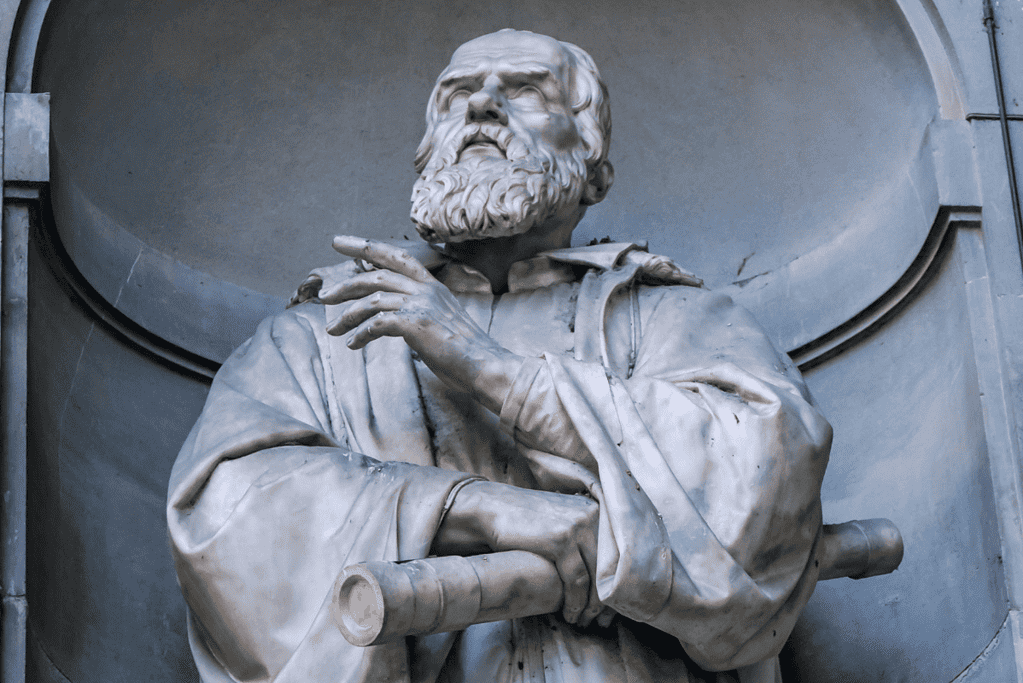 Image of a statue of Galileo, one of the famous astronomers, gripping the telescope through which he observed the heavens.