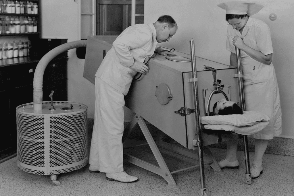Image of a patient receiving treatment in an iron lung