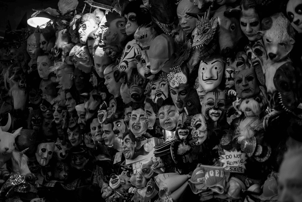 Image of a wall of halloween masks at a store.