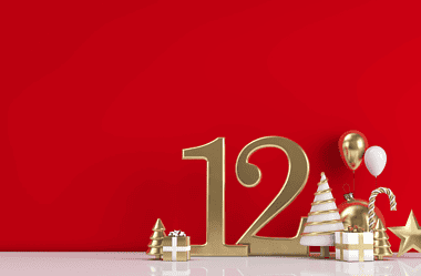 Image of a number 12 with Christmas decorations for a blog post covering the history of the 12 days of Christmas gift list.