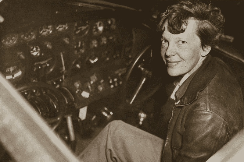 Image of legendary pilot Amelia Earhart in the cockpit for an article covering interesting facts about Amelia Earhart.