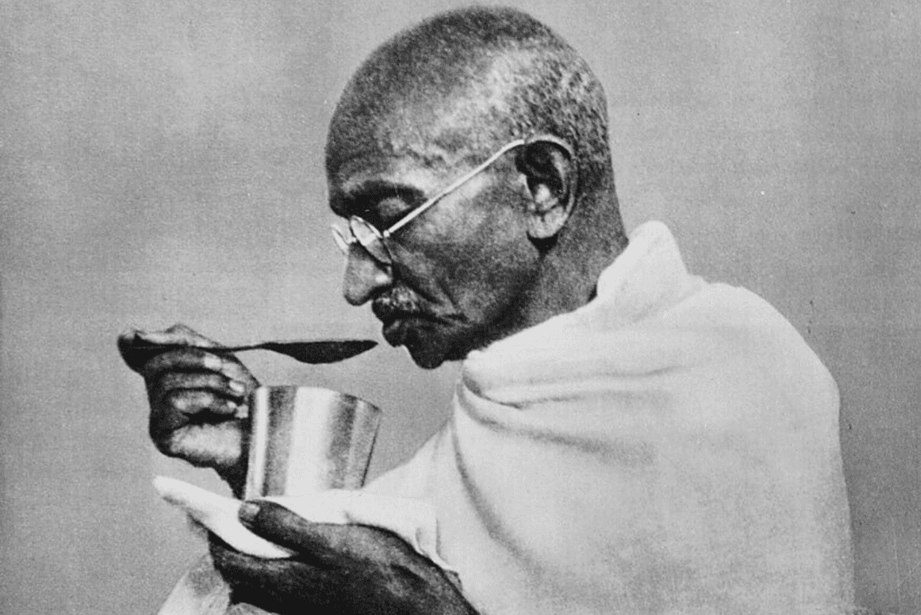 facts-about-mahatma-gandhi-vegetarian Image of Gandhi eating from a tin cup.