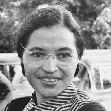 Image of a photo of Rosa Parks with Martin Luther King Jr. in the background for an article covering 10 interesting facts about Rosa Parks.