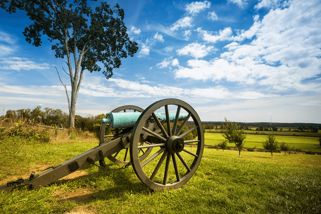 Image of a civil era cannon overlooking the Gettysburg battlefield for an article covering 10 interesting facts about the Gettysburg Address.