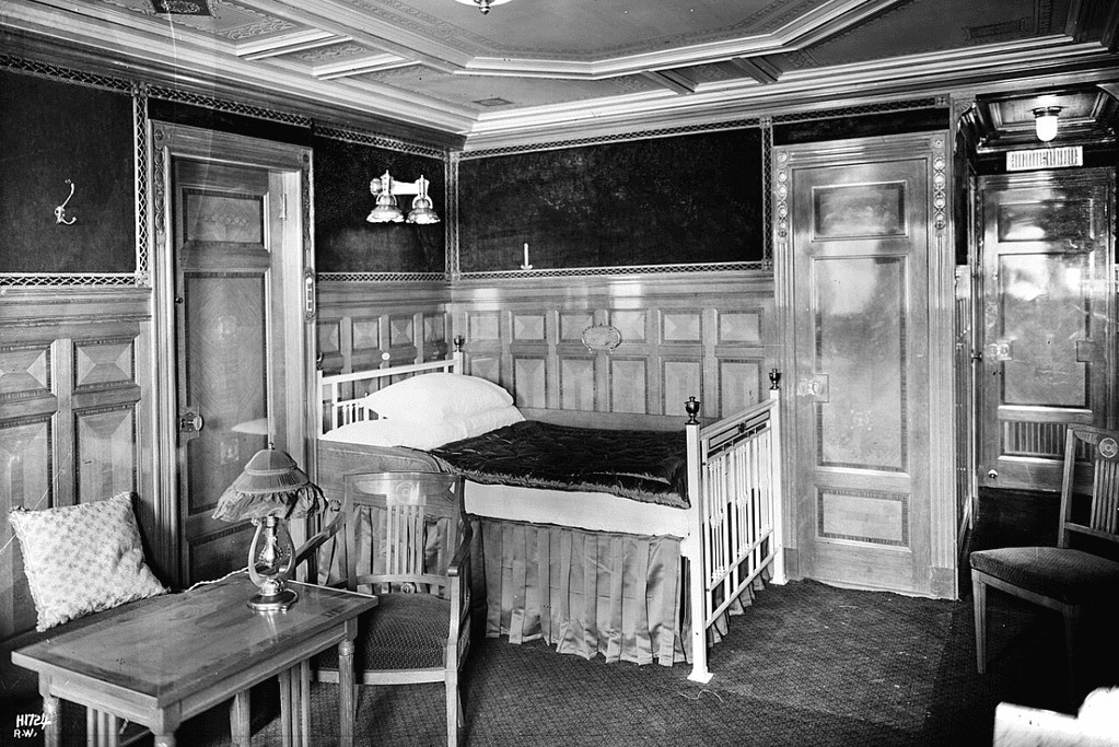 Image of an opulent first-class suite on the Titanic, highlighting the stark difference in comfort and amenities compared to second and third-class areas.