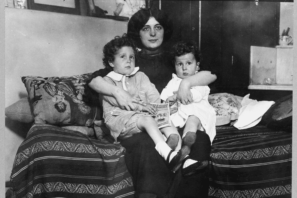 Image of a photo of a mother, who was rescued from the Titanic, cradling her little daughters in her lap, showing the resilience of survivors.