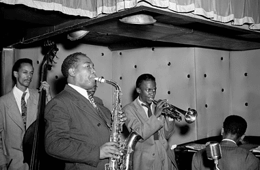 Image of jazz greats Charlie Parker, Tommy Potter, Miles Davis, and Duke Jordan for a blog post covering 10 facts on the jazz history timeline.