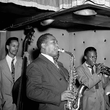 Image of jazz greats Charlie Parker, Tommy Potter, Miles Davis, and Duke Jordan for a blog post covering 10 facts on the jazz history timeline.