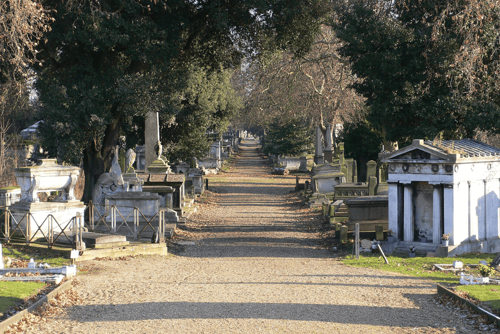 Image of various graves on a path through the oldes of London's Magnificent Seven Cemeteries, Kensal Green Cemetery
