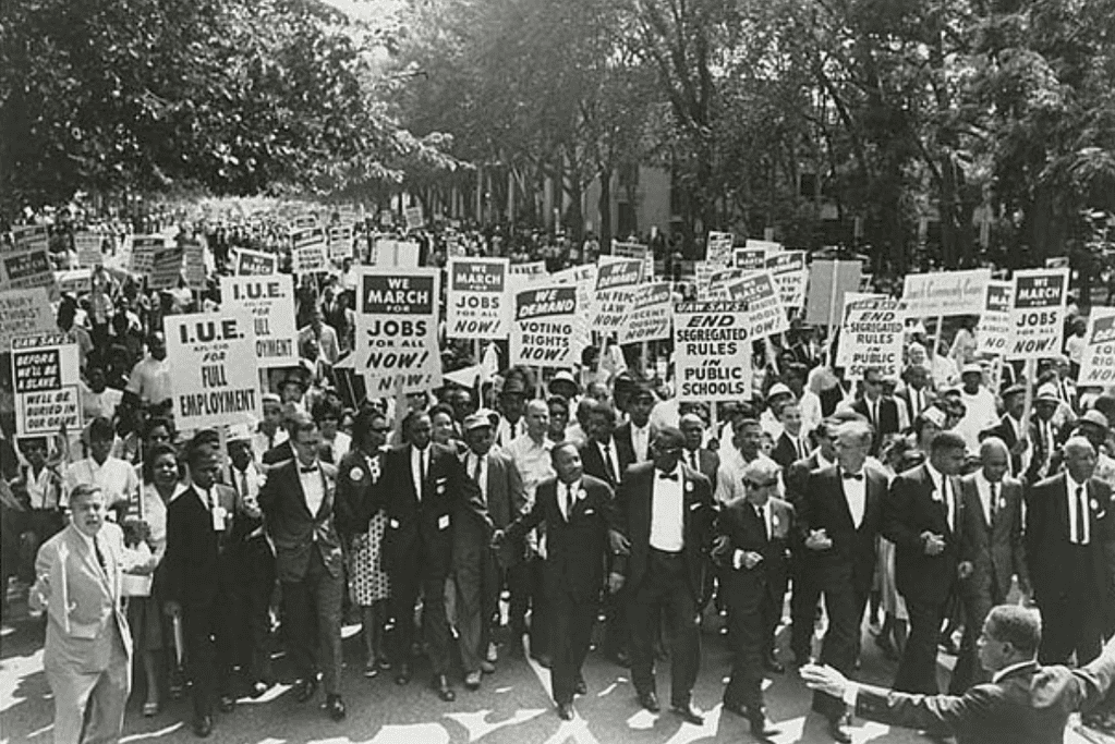 Image of MLK marching with protestors in support of the civil rights movement.