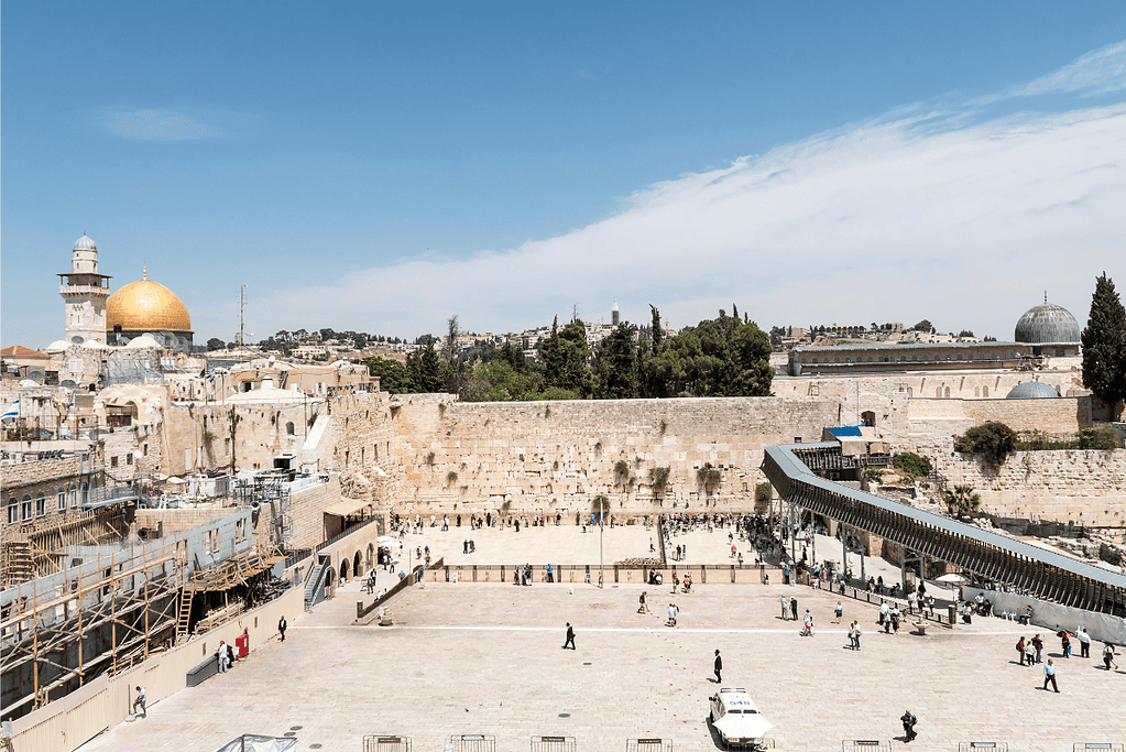 Image of the Western Wall with people praying in Jerusalem for a blog post covering biblical sites in Israel.