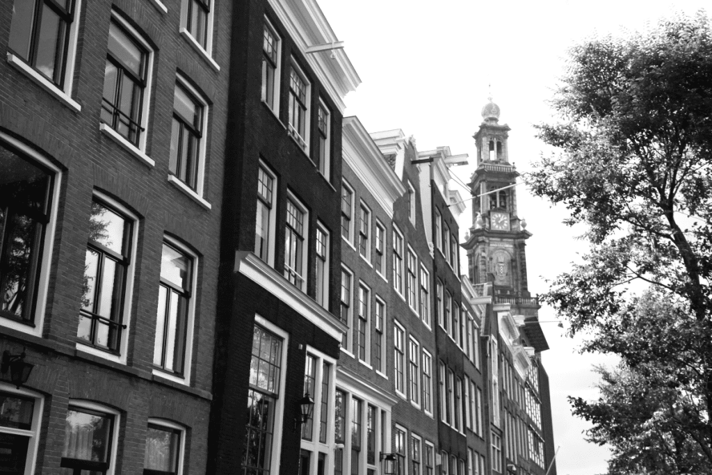 Image of a black and white photo of Anne Frank home along with several others.