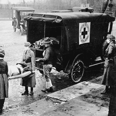 Image of nurses loading a patient into an ambulance during the Spanish Flu epidemic for a blog post covering pandemics throughout history.