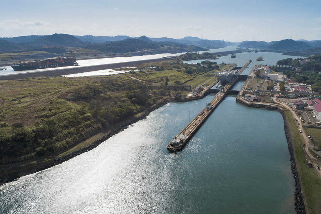Image of a long barge passing through the locks of the Panama Canal.