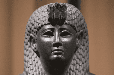 Image of a ancient basalt statue of Cleopatra for a blog post covering intriguing facts about Cleopatra.