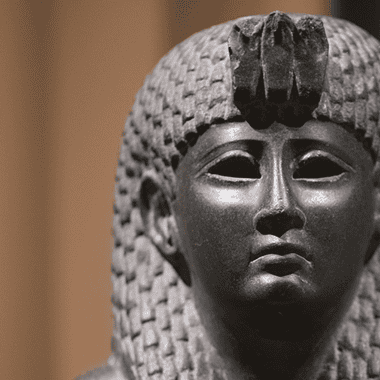 Image of a ancient basalt statue of Cleopatra for a blog post covering intriguing facts about Cleopatra.