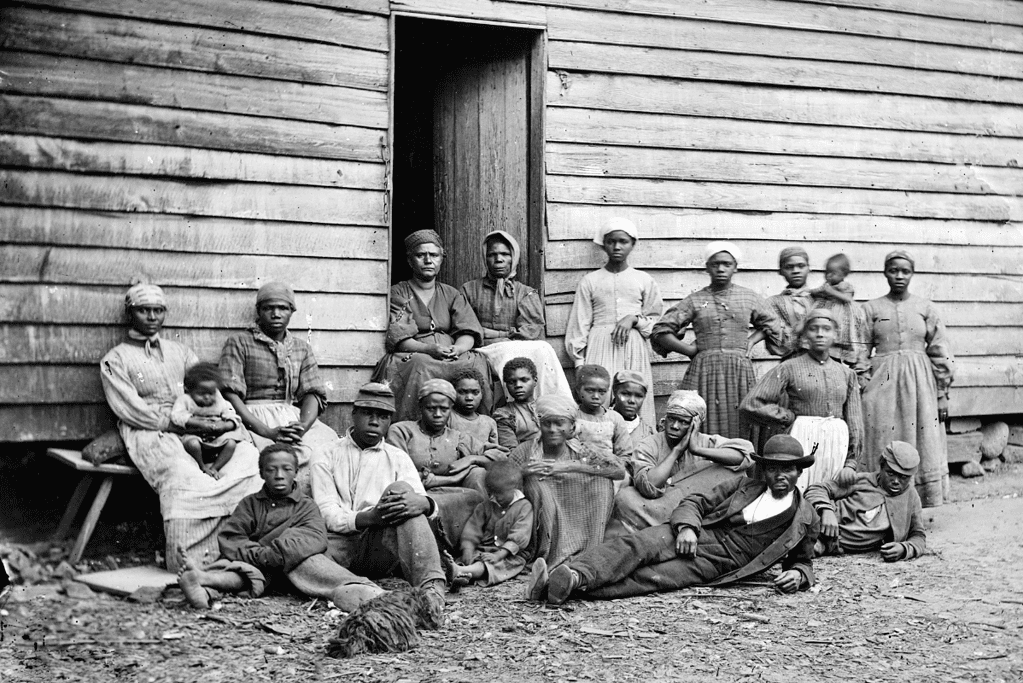 Image of enslaved individuals seated before a house in Virginia, 1862, for a blog post covering milestones leading to the Emancipation Proclamation.