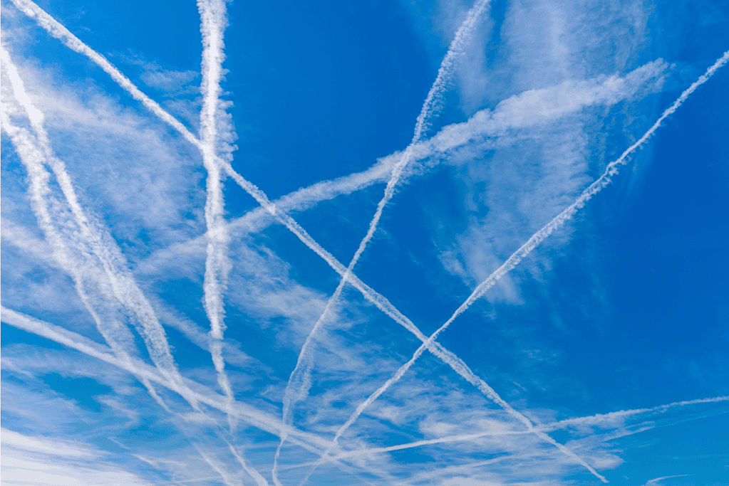 Image of contrails from numerous aircraft marking the sky.