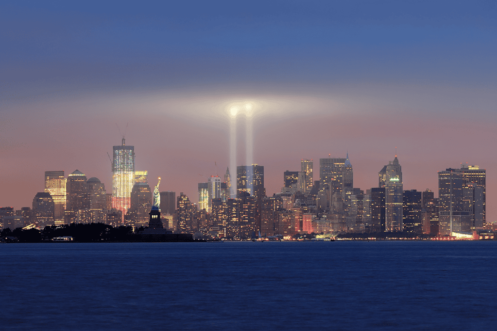 Image of two beams of light emanate from the 9/11 Memorial in downtown Manhattan for a blog post covering famous conspiracy theories.