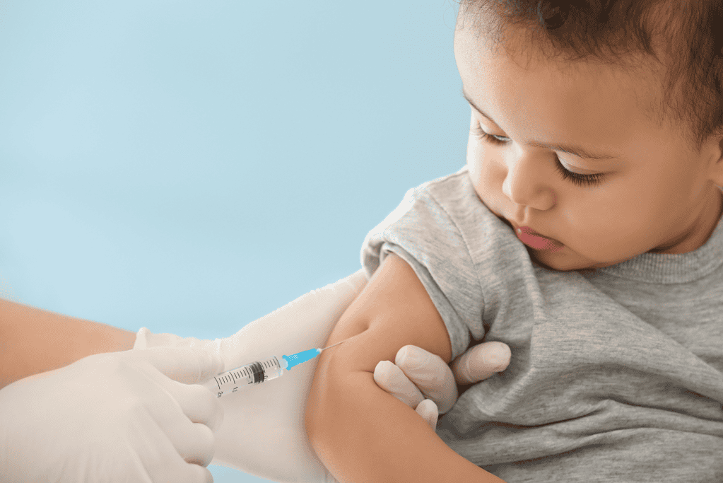 Image of a child receiving a vaccine from a nurse.