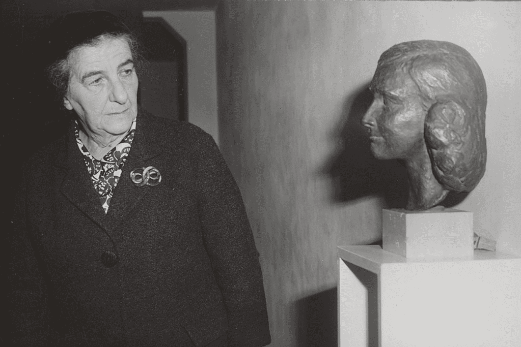 facts-about-golda-meir-artistic-inspiration Image of Golda Meir, studying a bust of Dutch holocaust victim Anne Frank.