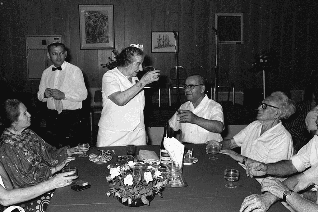 facts-about-golda-meir-culinary-diplomat Golda Meir raising her glass for a toast during a meeting for a blog post covering intriguing facts about Golda Meir.