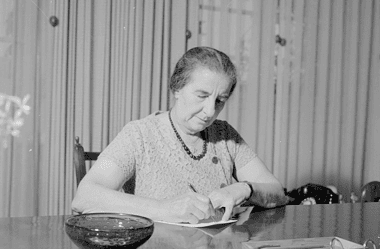Image of Israeli Prime Minister Golda Meir working at her desk for a blog post covering interesting facts about Golda Meir.