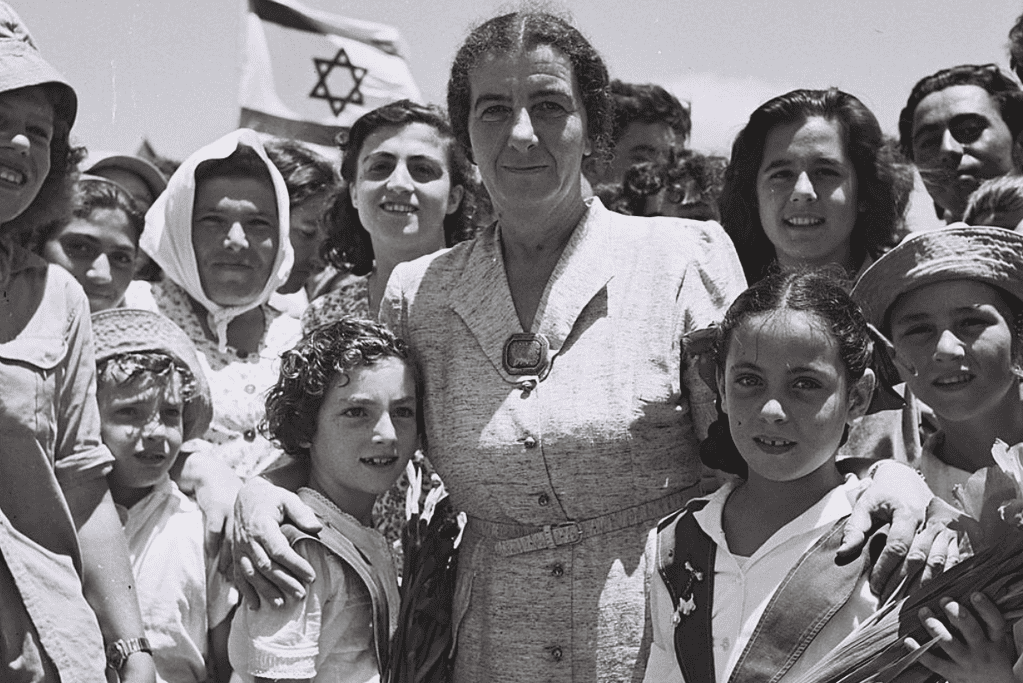 facts-about-golda-meir-kibbutz-pioneer Image of Golda Meir pictured with a crowd during a visit to a kibbutz.