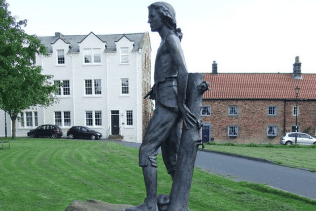 facts-about-james-cook-humble-beginnings Image of a statue of a young James Cook in Yorkshire, England for a blog post covering interesting facts about James Cook.