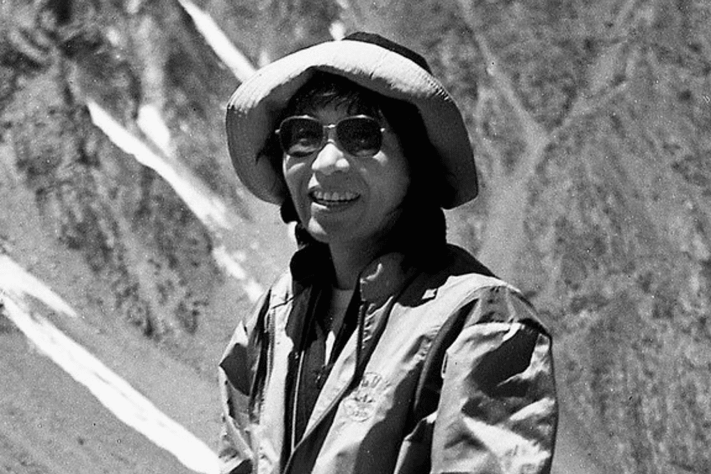 Image of Junko Tabei smiling while standing on an unknown mountainside.