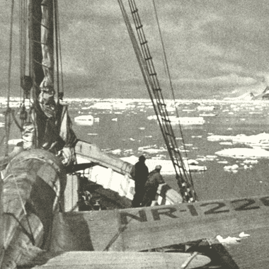 Image of a ship navigating ice floes in Antarctica for a blog post covering famous expeditions to antarctica.