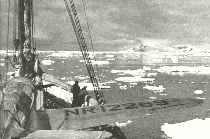 Image of a ship navigating ice floes in Antarctica for a blog post covering famous expeditions to antarctica.
